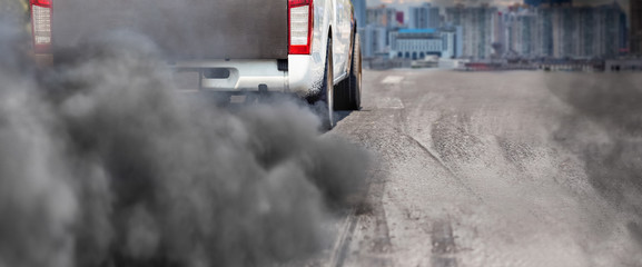 air pollution crisis in city from diesel vehicle exhaust pipe on road