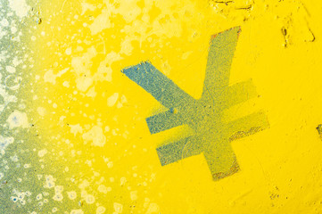 Sprayed yen currency mark on a wood panel