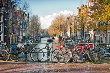 Obraz premium Scenic of bridge with bicycles parked over the canals of Amsterdam, Netherlands.