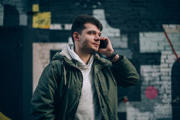 Man talking on the phone on the background of the cityscape