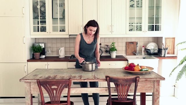 Female blogger filming her foods videos in the kitchen 
