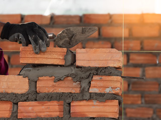 professional construction worker laying bricks