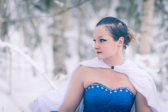 Lady in blue in midst of finnish winter forest