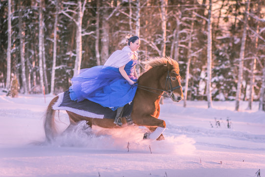 Lady in blue in midst of finnish winter forest
