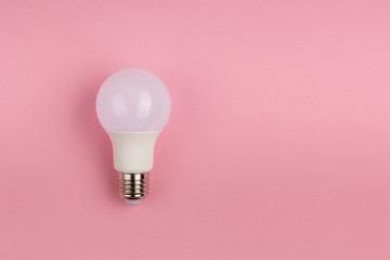 LED lamp on pink cloth background with copyspace