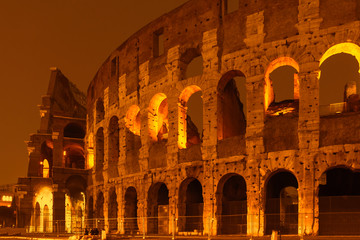 Roman Colloseum in Rome, Italy in the evening. Amber yellow sunset light.