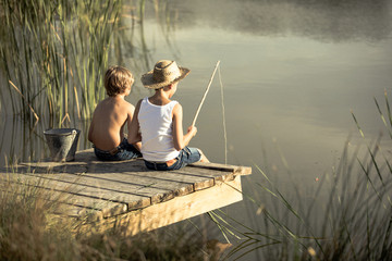 kids fishing in pond with jeans shorts