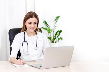 Young physician doing research in her office