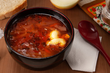 Traditional Ukrainian Russian borscht with sour cream on the bowl. Plate of red beet root soup borsch. Beetroot soup Top view. Traditional Ukraine food cuisine