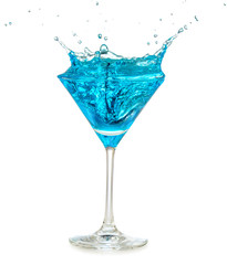 blue cocktail splashing in martini glass isolated on white