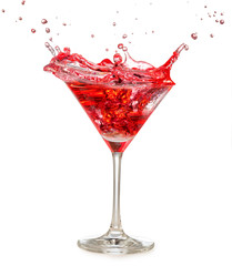 red cocktail splashing in martini glass isolated on white