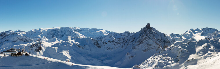 Fototapeta na wymiar Beautiful alpine panoramic view snow capped mountains. Winter mountain scenery.