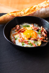 Food concept Fried egg and cheese bacon in cast iron skillet with copy space