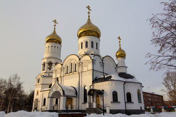 Fototapeta premium The temple stands majestically in the rays of the setting sun and is slightly powdered with snow.