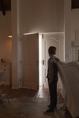 Boy standing and looking at door