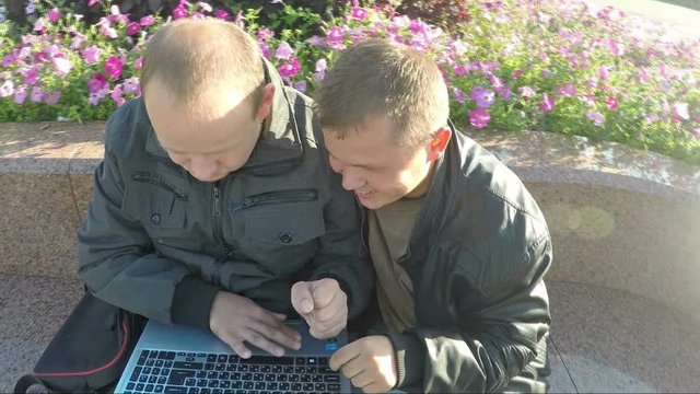 Two Happy Guys Looking At Laptop