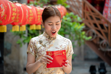 happy Chinese new year.Happy  asian woman in chinese traditional dress and holding red envelope