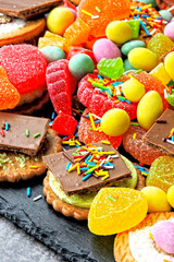 Unhealthy sweets. A set of sweets badly affecting the skin, body shape and well-being. Products containing excessive amounts of sugar. Harmful sweet foods. Unhealthy eating concept.