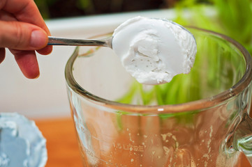 Adding coconut cream to a mixer or a blender