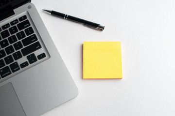 Notebook with black pen, Colorful notepads on the desk, Glasses on the desk with pen and cup of coffee, Computer keyboard with colorful note stick