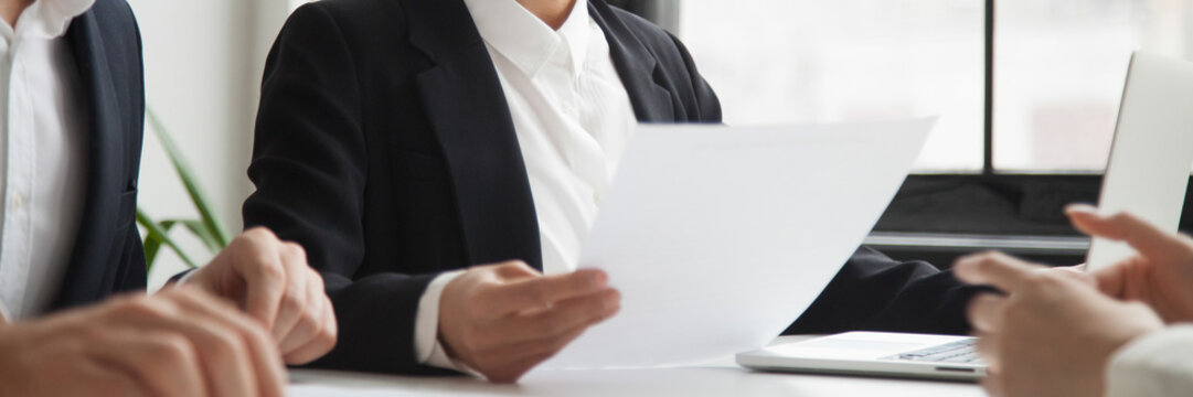 Close up horizontal photo hr manager female holding resume cv paper interviewing ask questions applicant vacancy candidate. Employment hiring first impression concept, banner for website header design