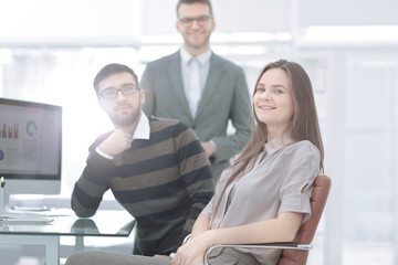 young employee of the company on the background of business team