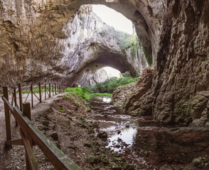 Devetashka cave interior, near Lovech town, Bulgaria. Tunnel of the cave with holes on the top