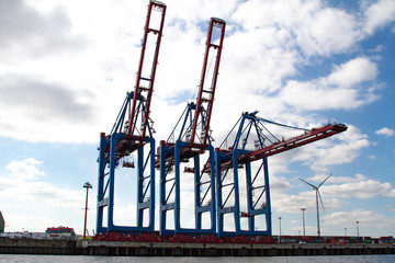 Fototapeta na wymiar Hamburg, Germany - September 03, 2014: three container cranes in a container terminal in Hamburg, Germany, waiting for new freight