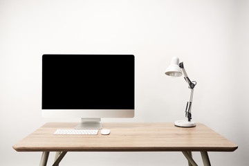 workplace with lamp and desktop computer with copy space isolated on white