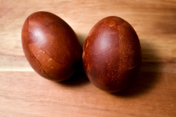 Naturally colored Easter eggs on wooden table. Eggs painted with onion skins. Easter holiday concept. 