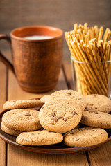  Oatmeal cookies and a cup of milk on a wooden table