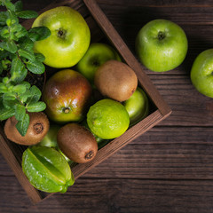 Set of green fruits for healthy diet and detox: apple, lime, kiwi, mango, carambola and mint.