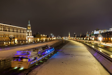 Fototapeta na wymiar Ship sails on the Moscow river near the Kremlin. 2019 New Year's decoration on the embankment of Moscow river