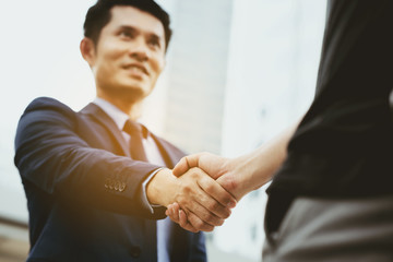 Close up at handshake is holding together, it is a promise to invest in doing business together. Become a partner to provide information. Modern marketing planning techniques. And succeeded with good.