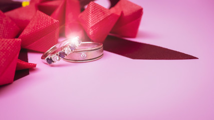 love object in valentine's day concept from paper heart and wedding ring decorate in pink pastel background