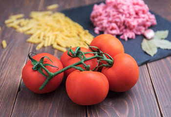 Ripe, red tomatoes on a wooden background