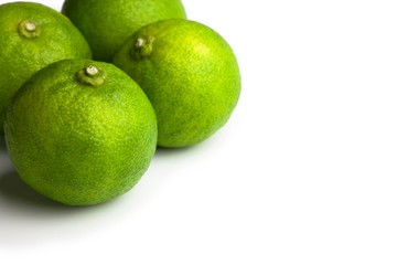 Asian kabosu lime ( Citrus sphaerocarpa ), Often used on Asian cooked fish, sashimi, and hot pot dishes,  isolated on white.