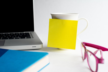 Notebook with black pen, Colorful notepads on the desk, Glasses on the desk with pen and cup of coffee, Computer keyboard with colorful note stick