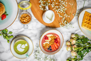 spring breakfast on the table with green tea latte with oatmeal, waffles and flowers