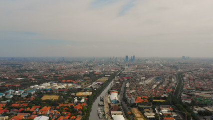 Aerial cityscape densely built asian city, seaport. urban environment in asia. modern city Surabaya with buildings and houses. Surabaya capital city east java, indonesia