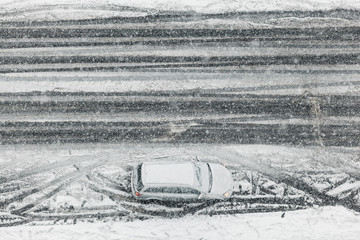 Car parked on the street in a snowy weather