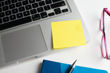 Notebook with black pen, Colorful notepads on the desk, Glasses on the desk with pen and cup of coffee, Computer keyboard with colorful note stick