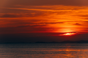 Obraz premium Beautiful blazing sunset landscape and orange sky above it,summer background.