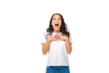 Excited asian woman in white t-shirt holding hands on chest isolated on white