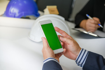 Businessmen are using mobile phones, During the team meeting with engineers, in searching for information, to technology concept.