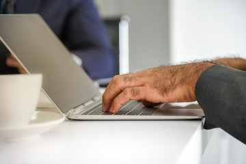 The businessmen are using notebooks to fine information and plan tasks during meeting with the work team, at workplace to business concept.