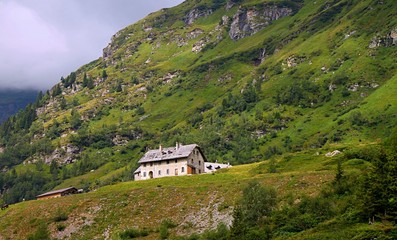 Vibrant vew of Alpen foggy valley in summer Austria with village houses
