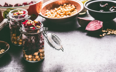 Healthy homemade beetroot salad with chickpeas and pine nuts in glasses for lunch on dark kitchen...