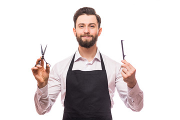 Portrait of cheerful joyful barber with stubble in shirt having scissors, tools, equipments in...