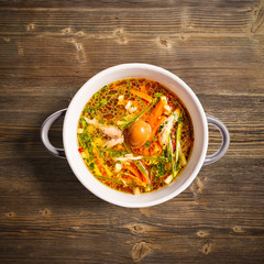 Rooster soup with smoked quail egg